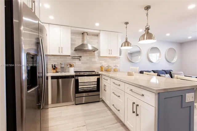 a kitchen with stainless steel appliances a sink stove and refrigerator