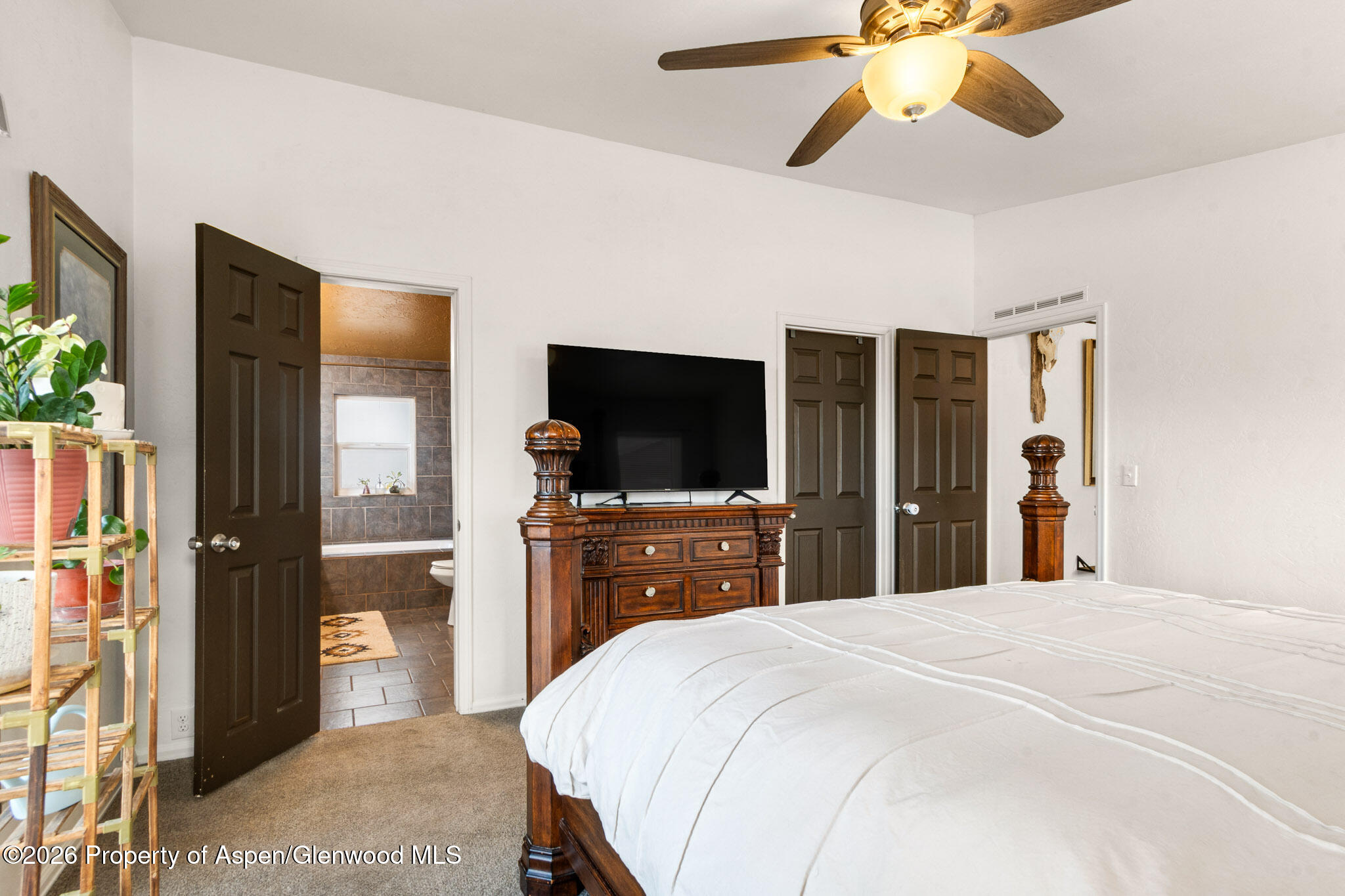 106 Cedar Circle Parachute, CO 81635 - Photo 20 of 35 a bedroom with a bed and a flat screen tv