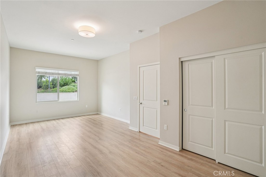 143 Frame Irvine, CA 92618 - Photo 20 of 41 a view of an empty room with wooden floor and a window