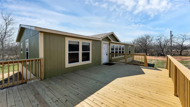 a view of a house with wooden deck