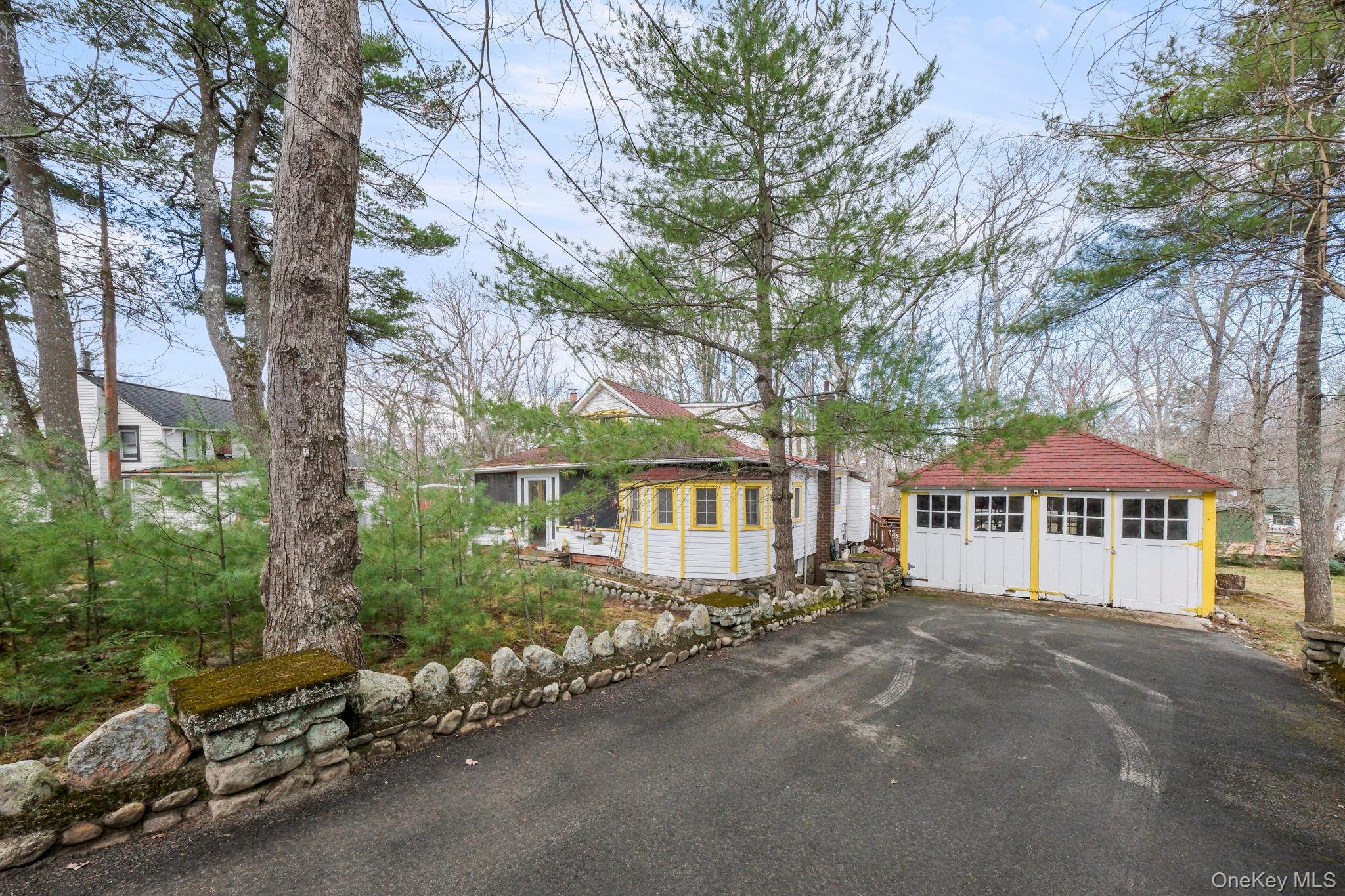 View of front of property with asphalt driveway