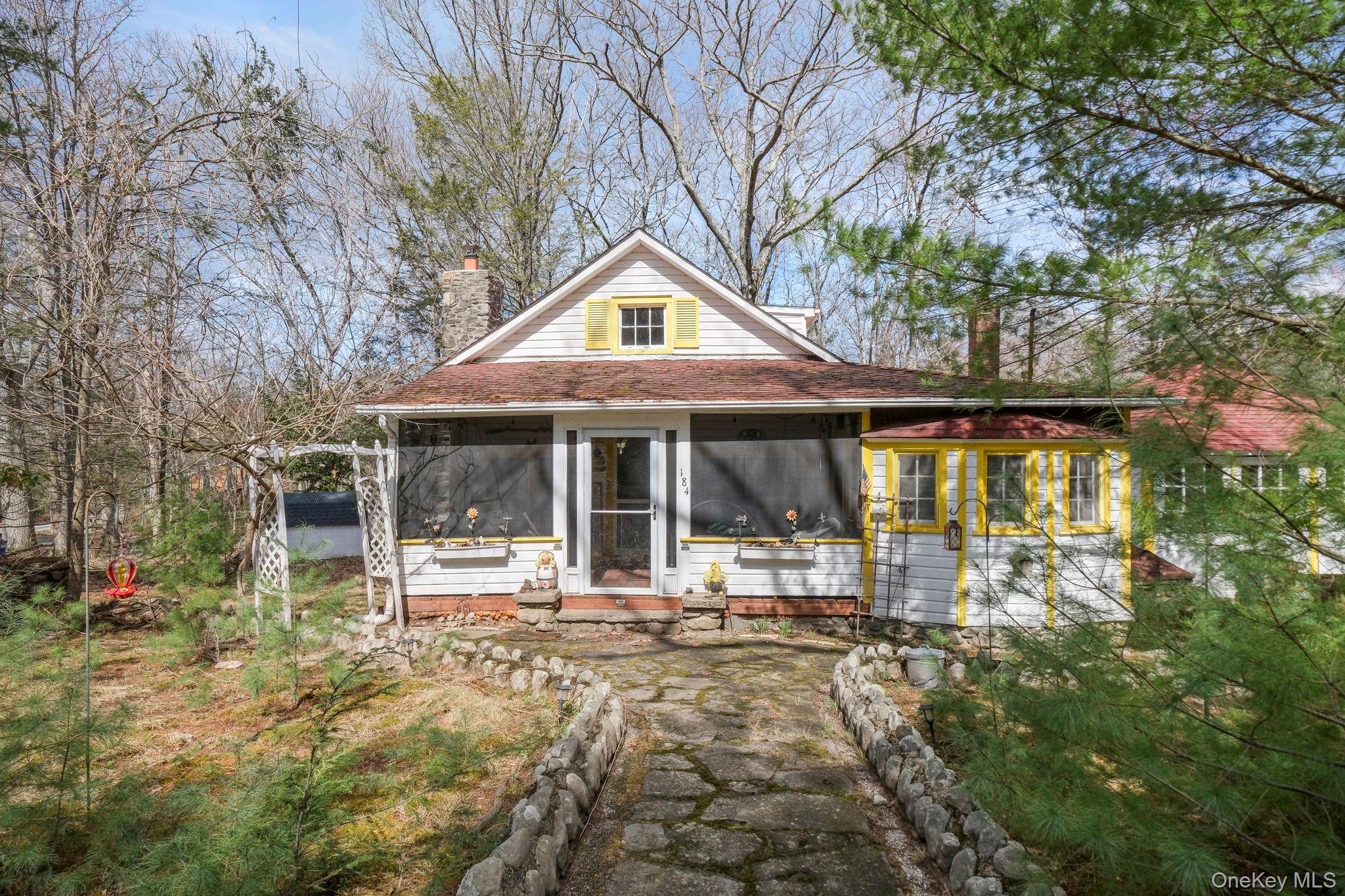 184 Yankee Lake Road Wurtsboro, NY 12790 - Photo 17 of 27 View of front of house with a sunroom and a chimney