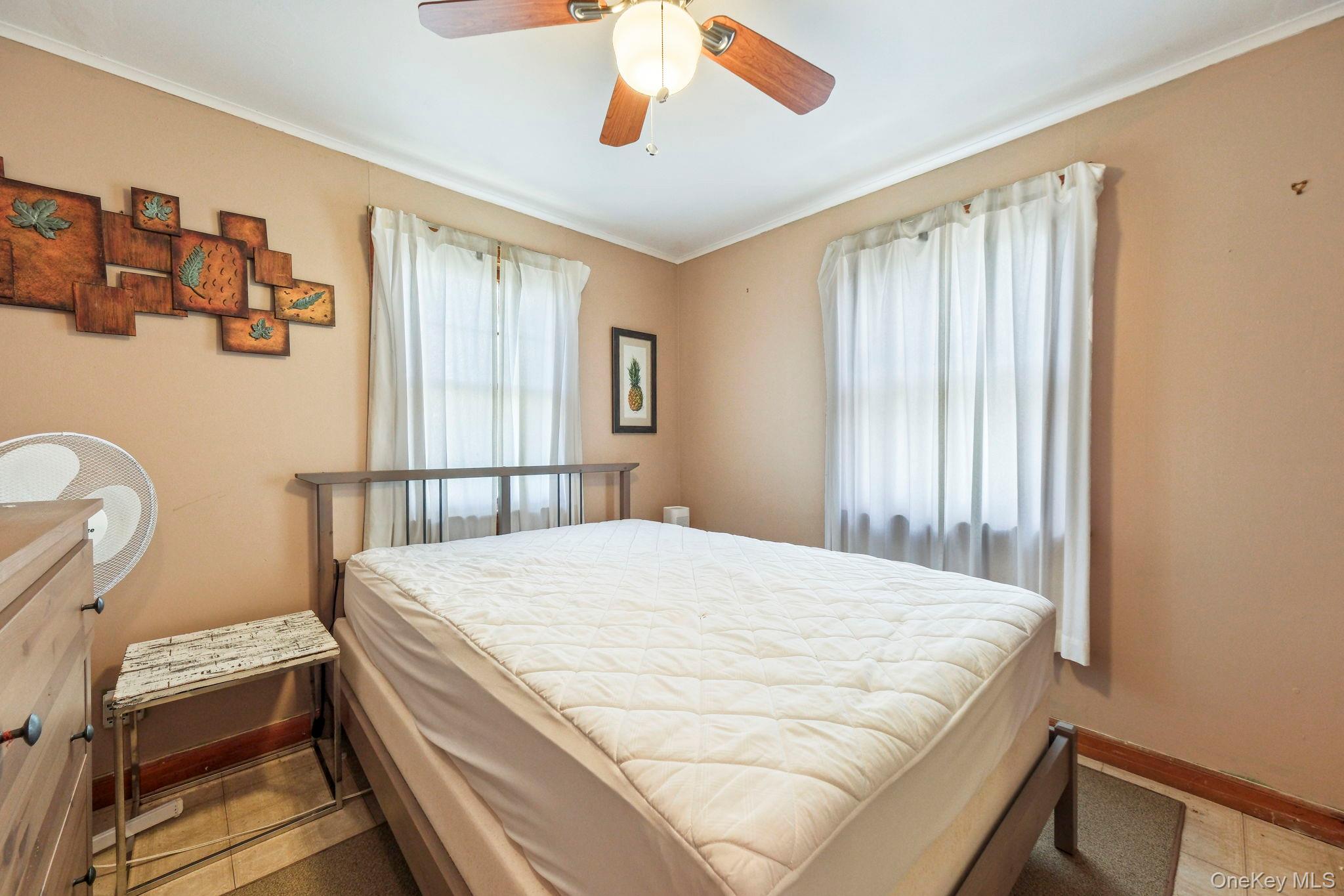 184 Yankee Lake Road Wurtsboro, NY 12790 - Photo 19 of 27 Bedroom featuring ceiling fan and crown molding