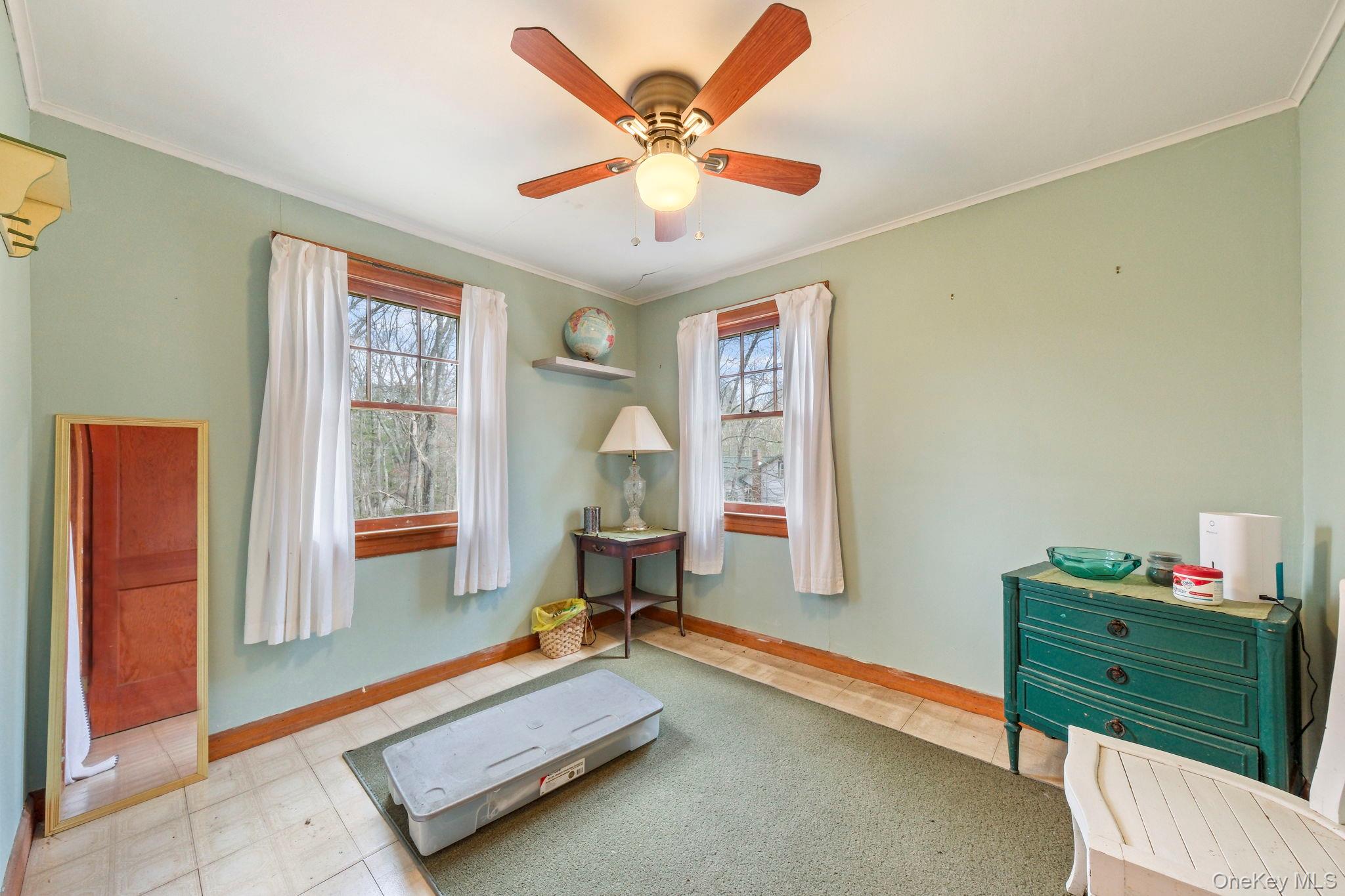 184 Yankee Lake Road Wurtsboro, NY 12790 - Photo 20 of 27 Exercise area or bedroom featuring light floors, ornamental molding, ceiling fan, and healthy amount of natural light