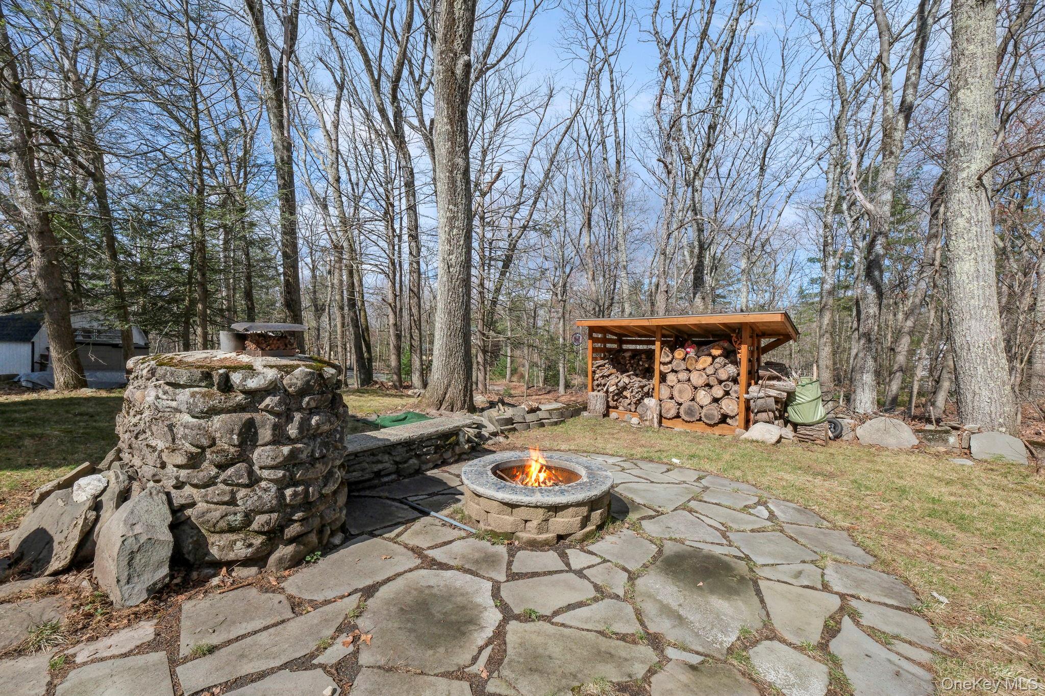 184 Yankee Lake Road Wurtsboro, NY 12790 - Photo 22 of 27 View of patio with a fire pit and an outbuilding