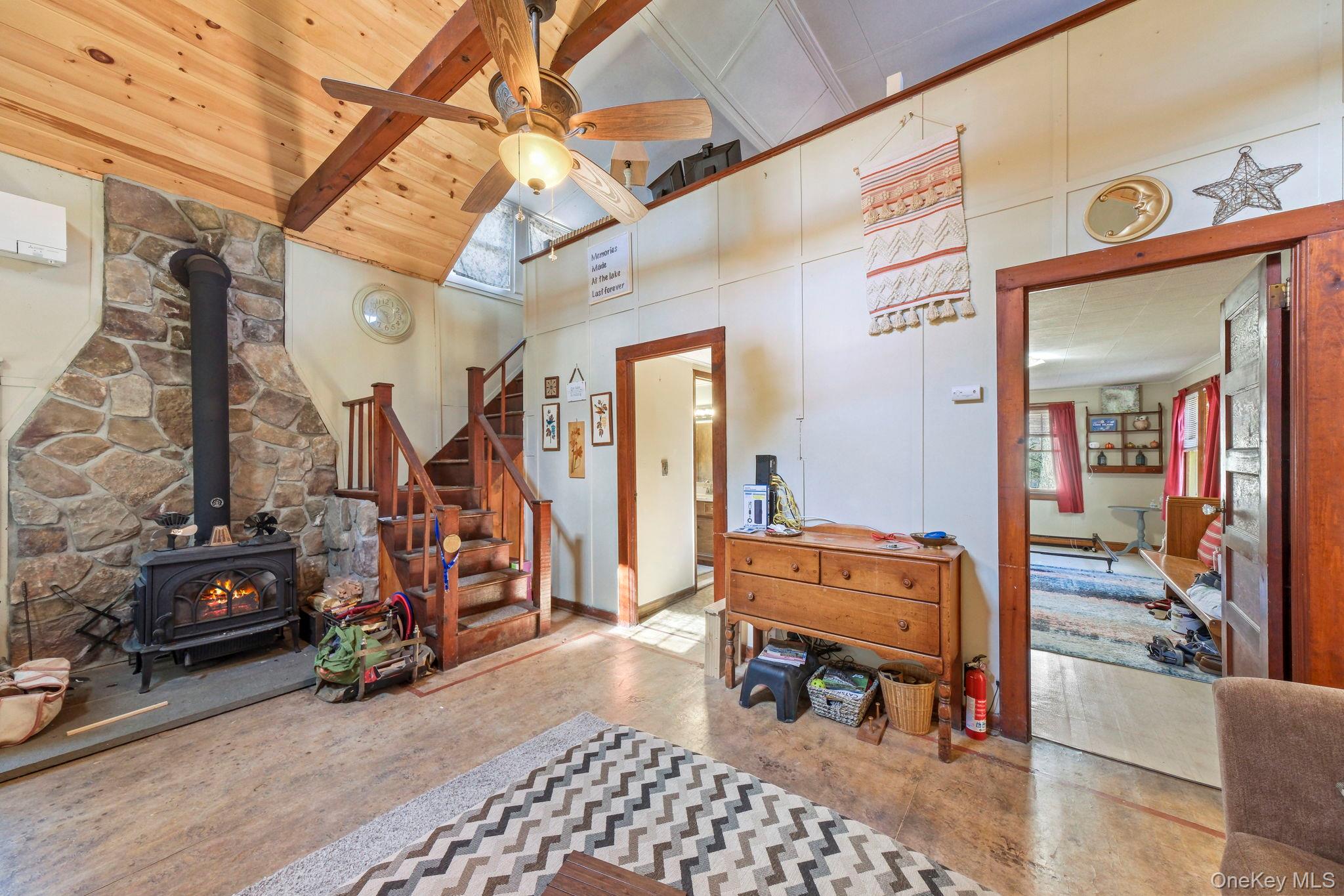 184 Yankee Lake Road Wurtsboro, NY 12790 - Photo 3 of 27 Entrance foyer with a wood stove, a ceiling fan, and vaulted ceiling