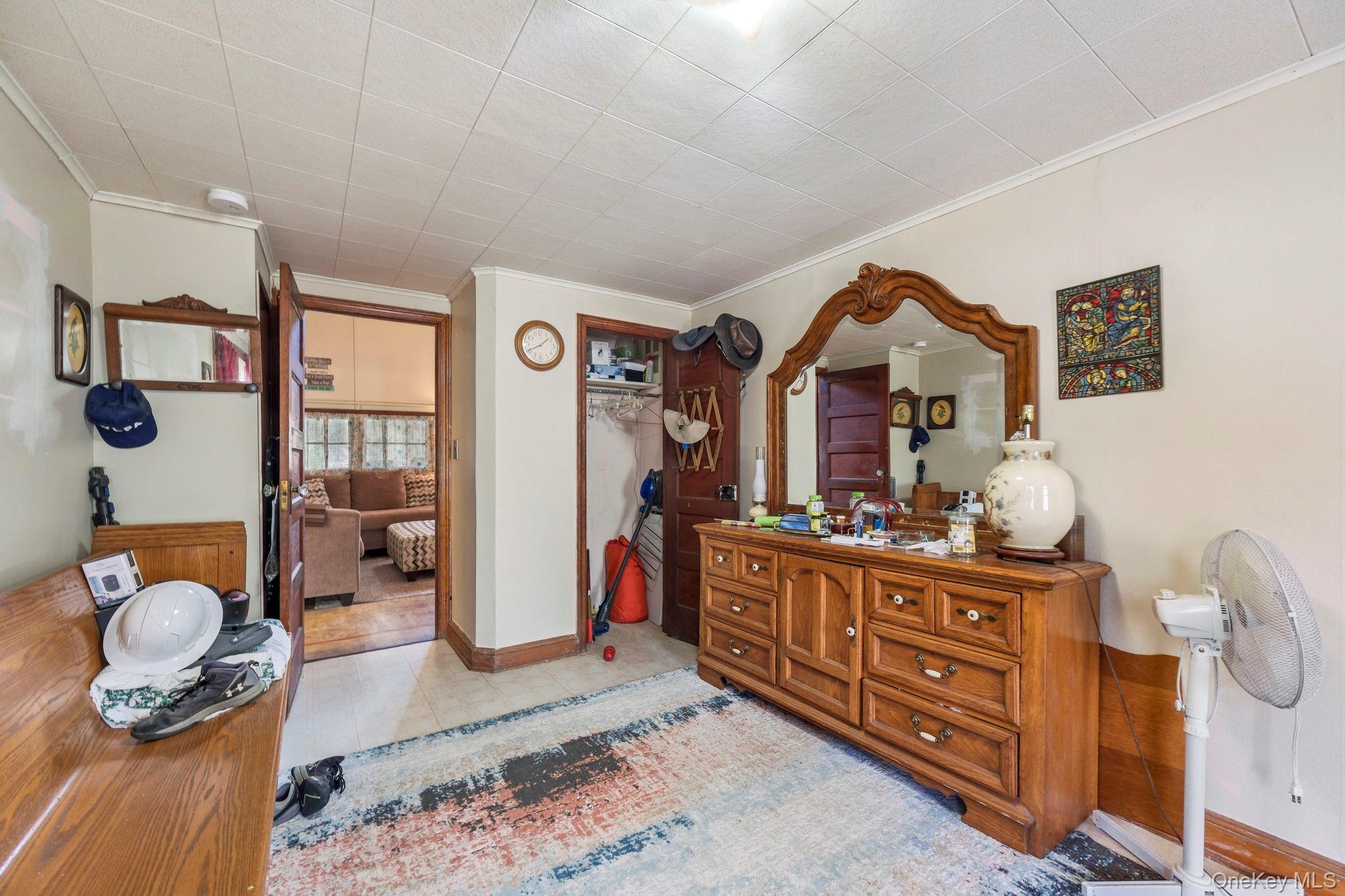 184 Yankee Lake Road Wurtsboro, NY 12790 - Photo 10 of 27 Bedroom featuring a closet and crown molding