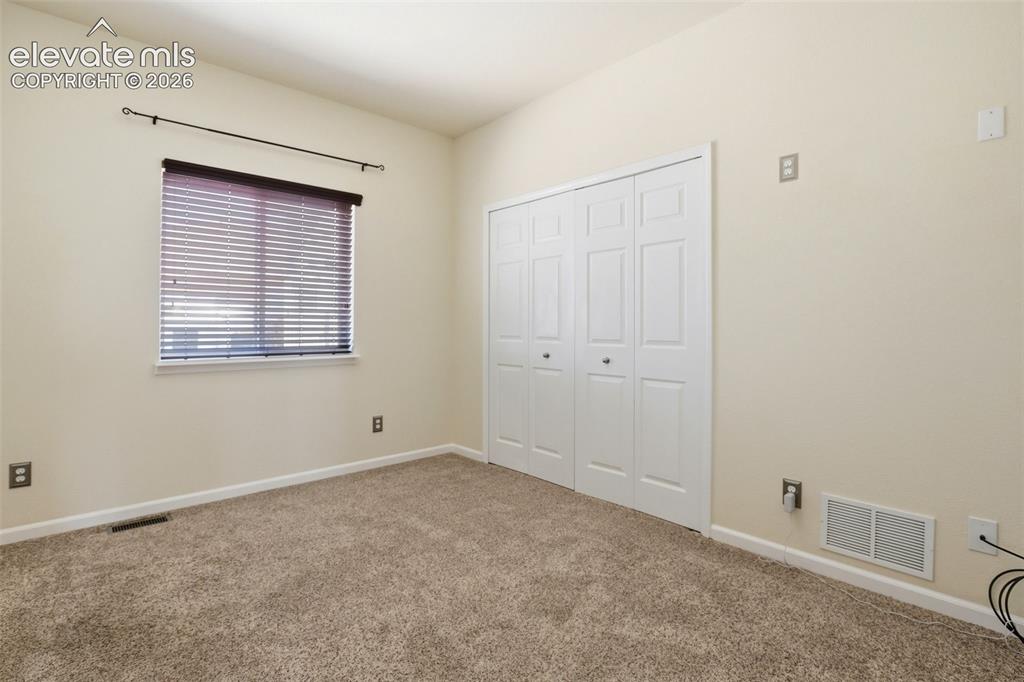 7806 Dutch Loop Colorado Springs, CO 80925 - Photo 18 of 41 an empty room with windows