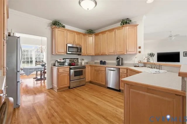 a kitchen with stainless steel appliances granite countertop a refrigerator and a stove top oven