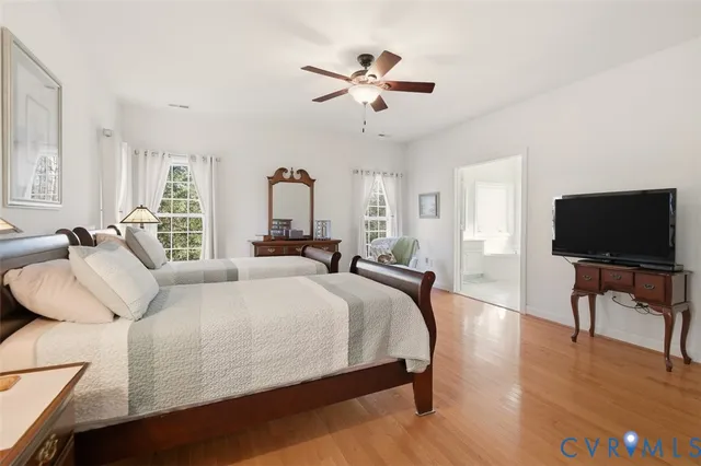 a bathroom with a sink a toilet a mirror and shower curtain