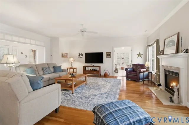 a living room with furniture fireplace and window