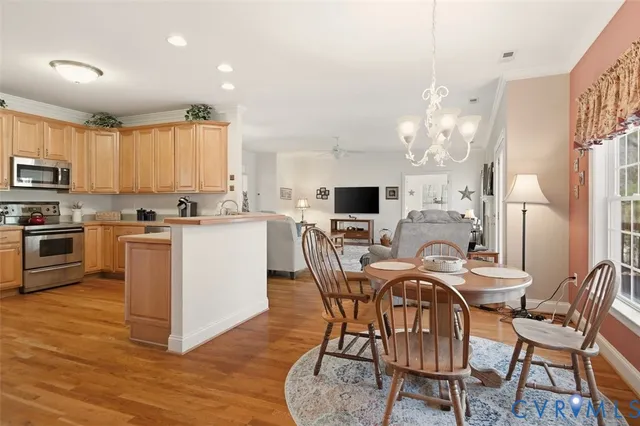 a view of a dining room with furniture and chandelier