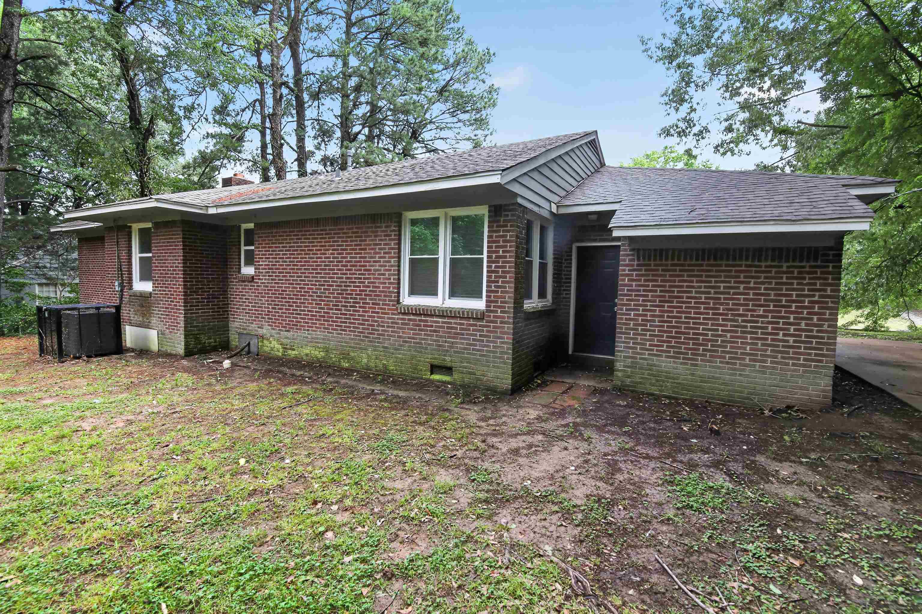 318 East Raines Road Memphis, TN 38109 - Photo 6 of 28 Brick exterior with multiple windows and a shingled roof