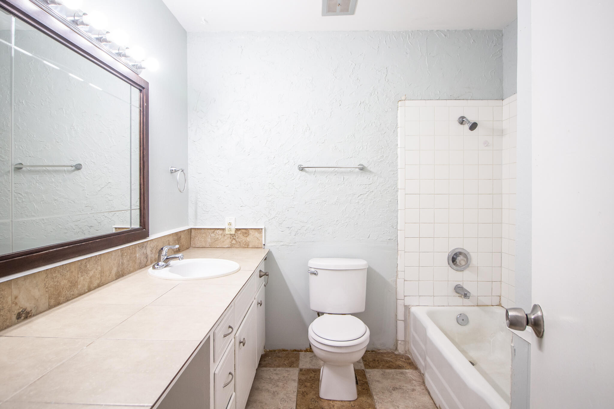 2105 49th Street Lubbock, TX 79412 - Photo 13 of 31 a bathroom with a granite countertop sink a toilet and bathtub