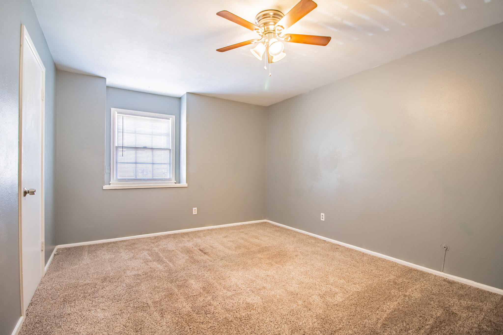 2105 49th Street Lubbock, TX 79412 - Photo 27 of 31 an empty room with chandelier fan and windows