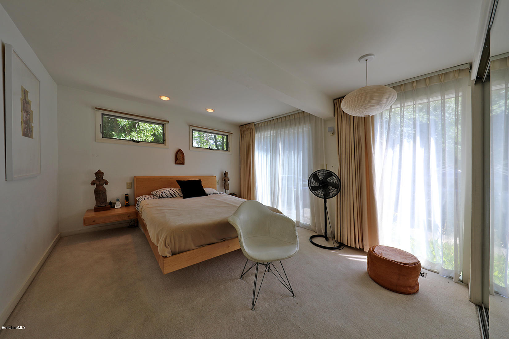 13 Hill Road Stockbridge, MA 01262 - Photo 13 of 27 a bedroom with a bed and a chandelier