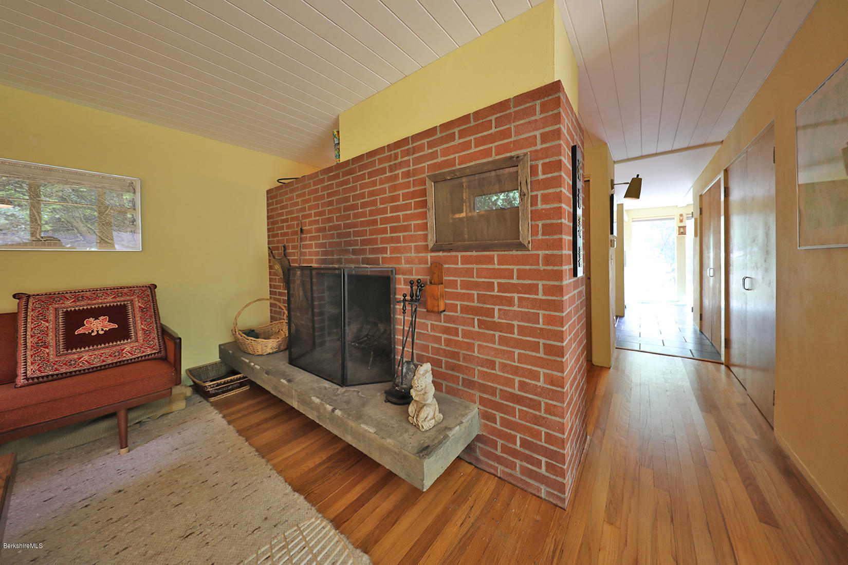 13 Hill Road Stockbridge, MA 01262 - Photo 8 of 27 a living room with furniture wooden floor and a fireplace