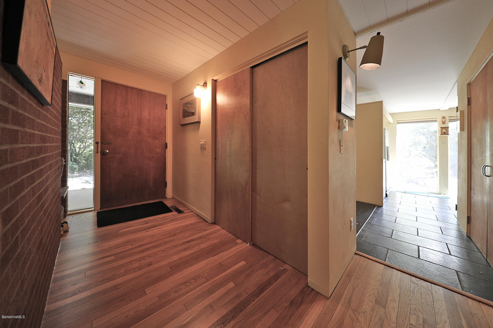 13 Hill Road Stockbridge, MA 01262 - Photo 10 of 27 a view of hallway with a large mirror and a wooden floor
