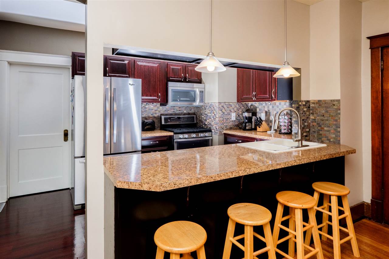 336 North 12th Street Rochelle, IL 61068 - Photo 8 of 24 a kitchen with stainless steel appliances granite countertop a sink and a refrigerator