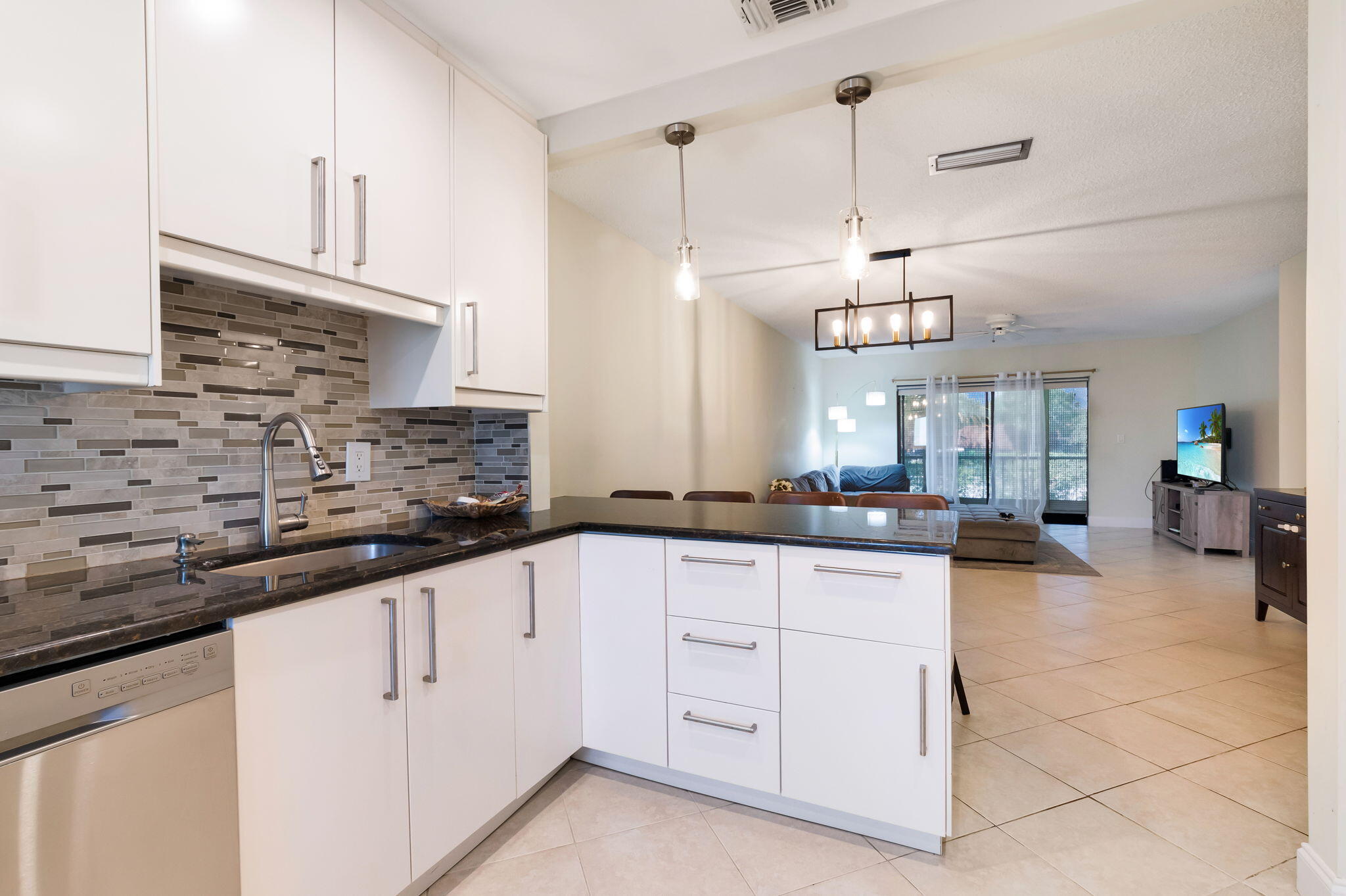 1700 Dover Road, Unit 204A Delray Beach, FL 33445 - Photo 12 of 33 a kitchen with white cabinets and sink