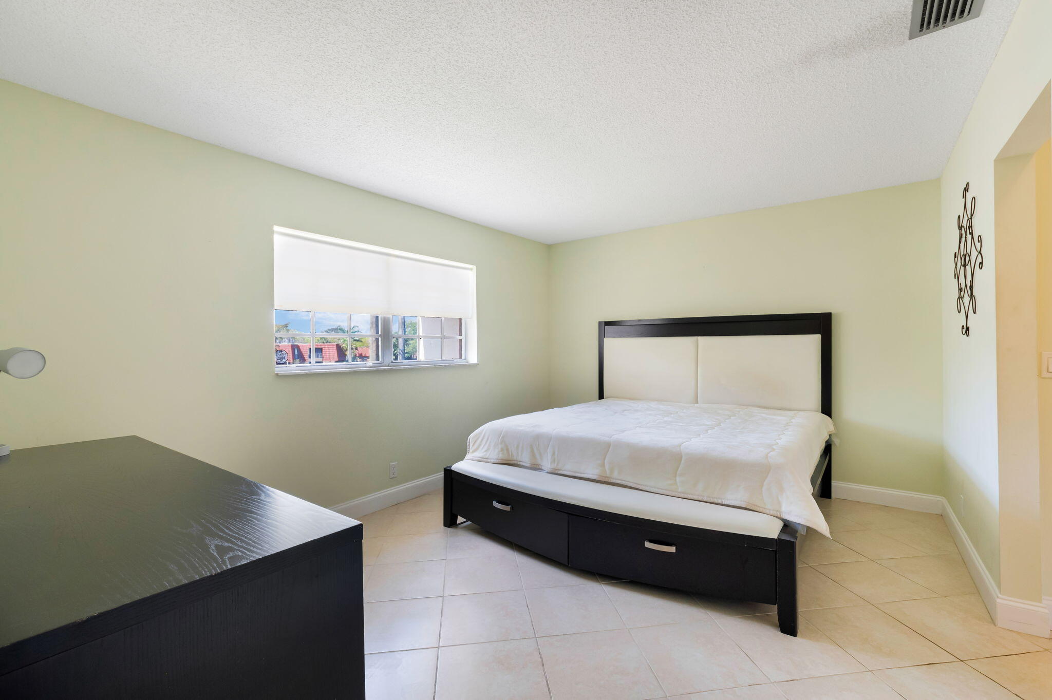 1700 Dover Road, Unit 204A Delray Beach, FL 33445 - Photo 13 of 33 a bedroom with a bed and a window