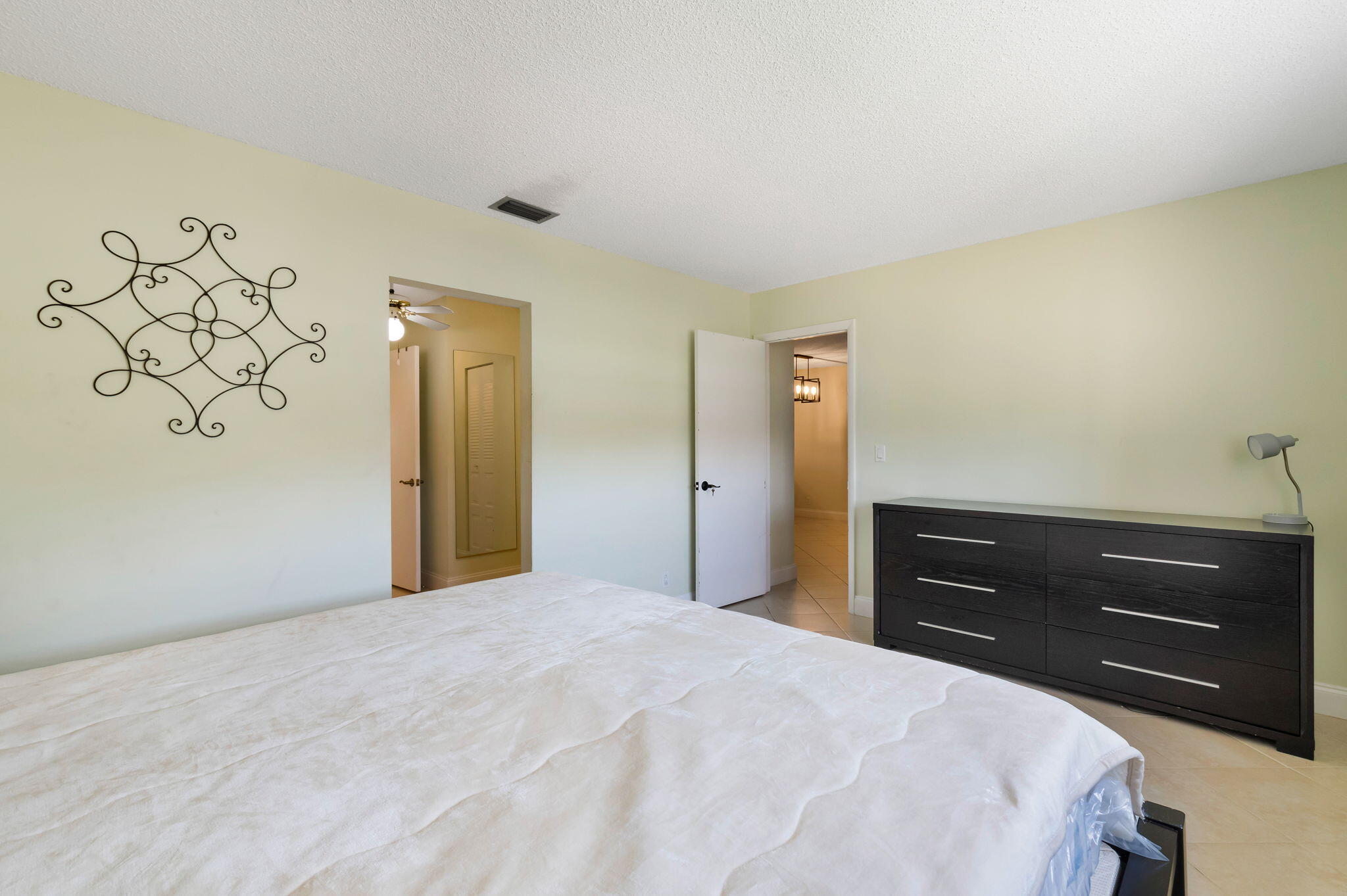 1700 Dover Road, Unit 204A Delray Beach, FL 33445 - Photo 15 of 33 a bedroom with a bed and a dresser