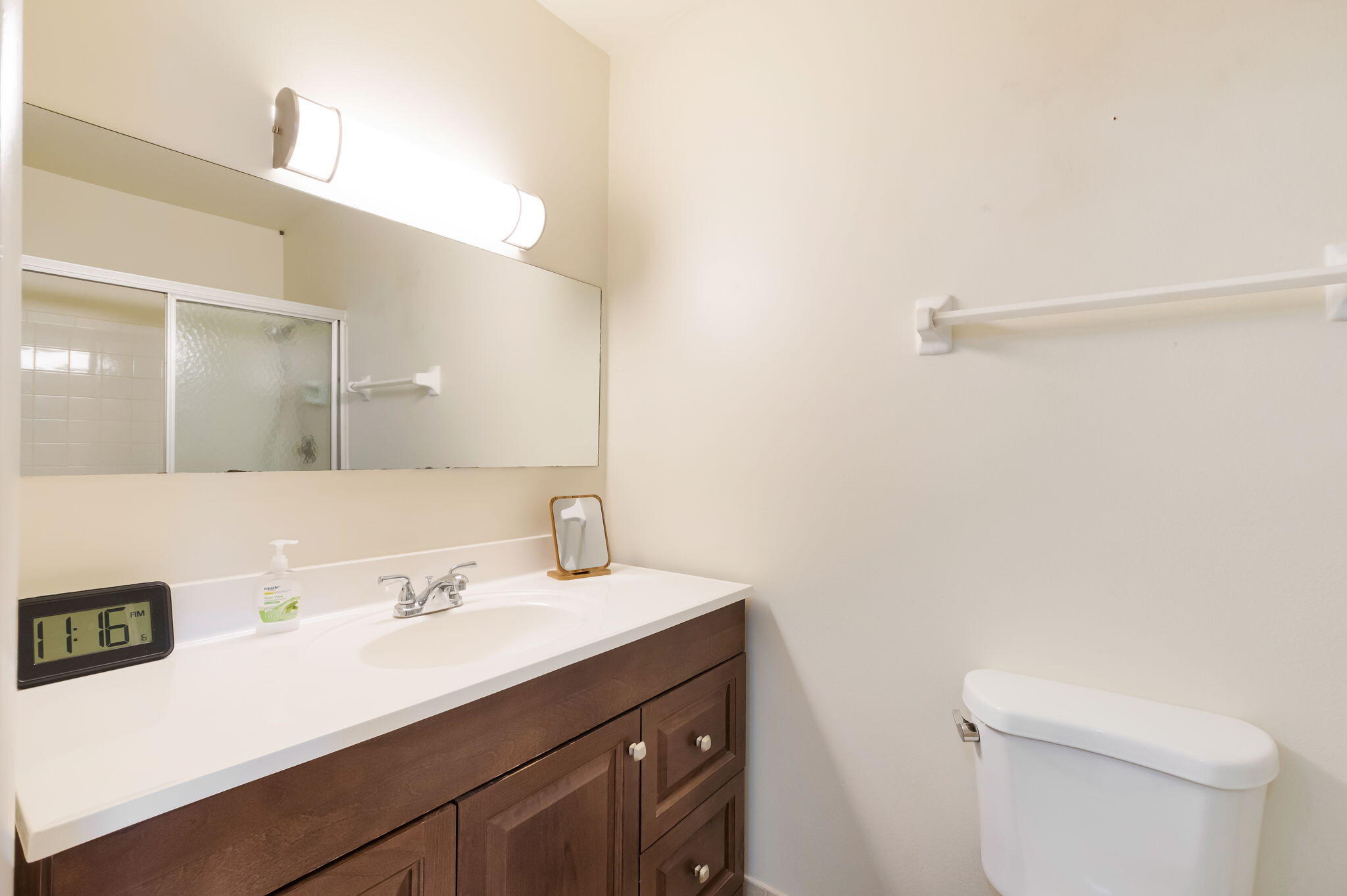 1700 Dover Road, Unit 204A Delray Beach, FL 33445 - Photo 18 of 33 a bathroom with a sink a toilet and a mirror