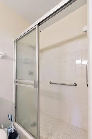 a bathroom with a glass shower door