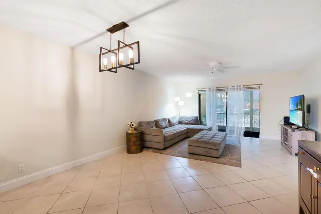 a living room with couches and chandelier