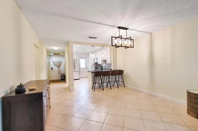 a view of a dining room with furniture and a chandelier fan