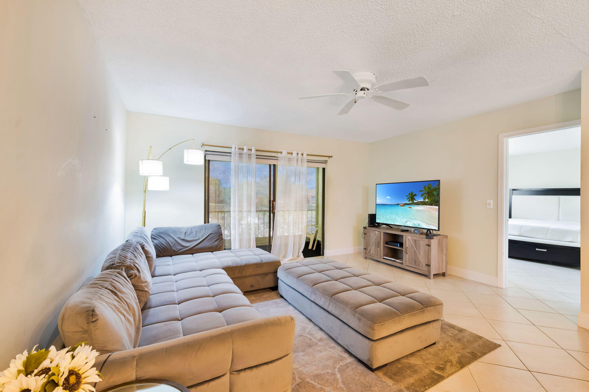 1700 Dover Road, Unit 204A Delray Beach, FL 33445 - Photo 22 of 33 a living room with furniture a flat screen tv and a couch