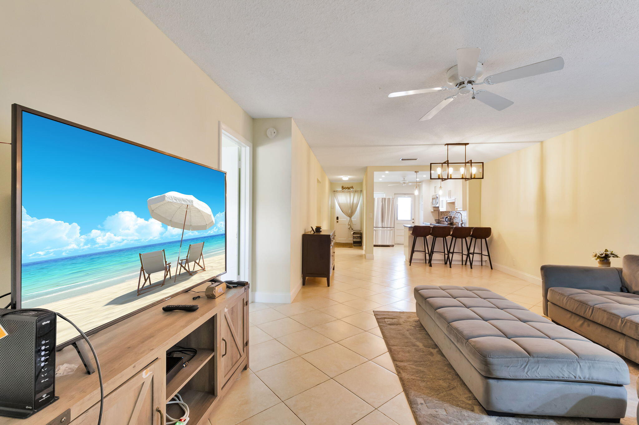 1700 Dover Road, Unit 204A Delray Beach, FL 33445 - Photo 24 of 33 a living room with furniture a flat screen tv and a large window