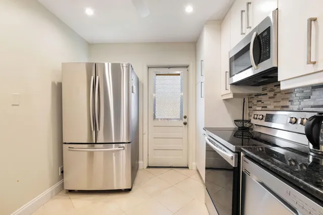 a kitchen with appliances and cabinets