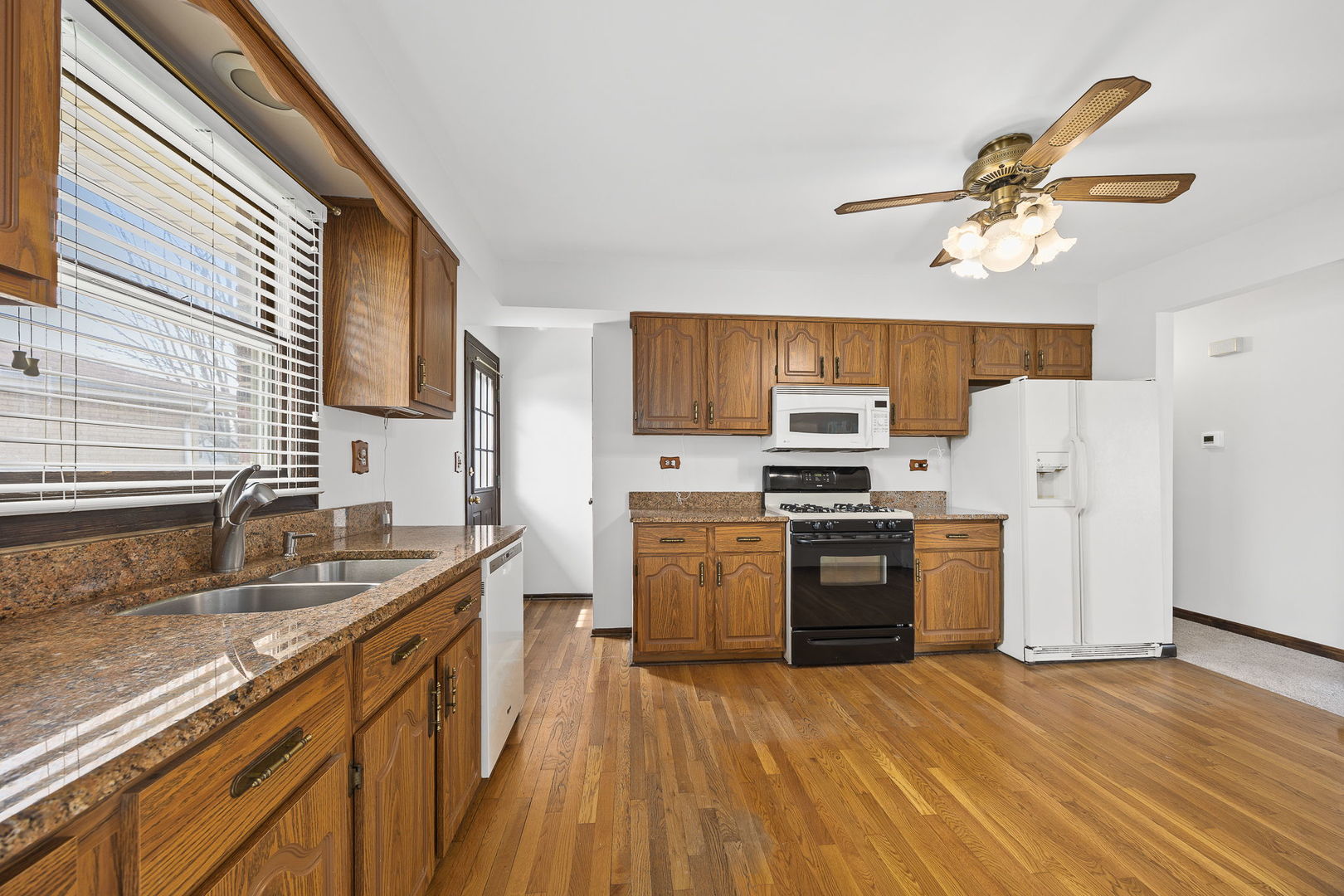 494 Flint Trail Carol Stream, IL 60188 - Photo 16 of 37 a kitchen with a sink wooden floor and stainless steel appliances