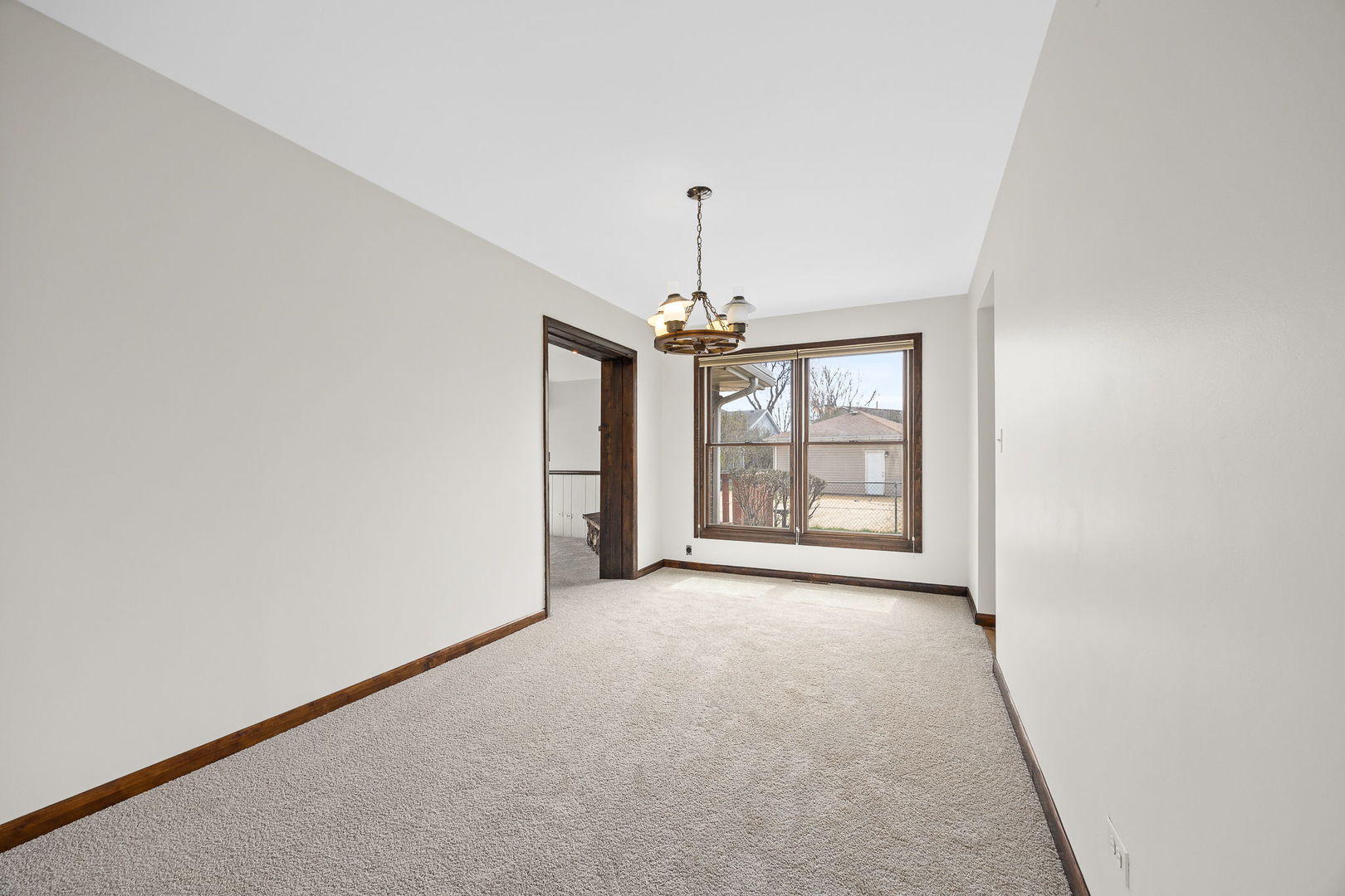 494 Flint Trail Carol Stream, IL 60188 - Photo 17 of 37 an empty room with windows and chandelier