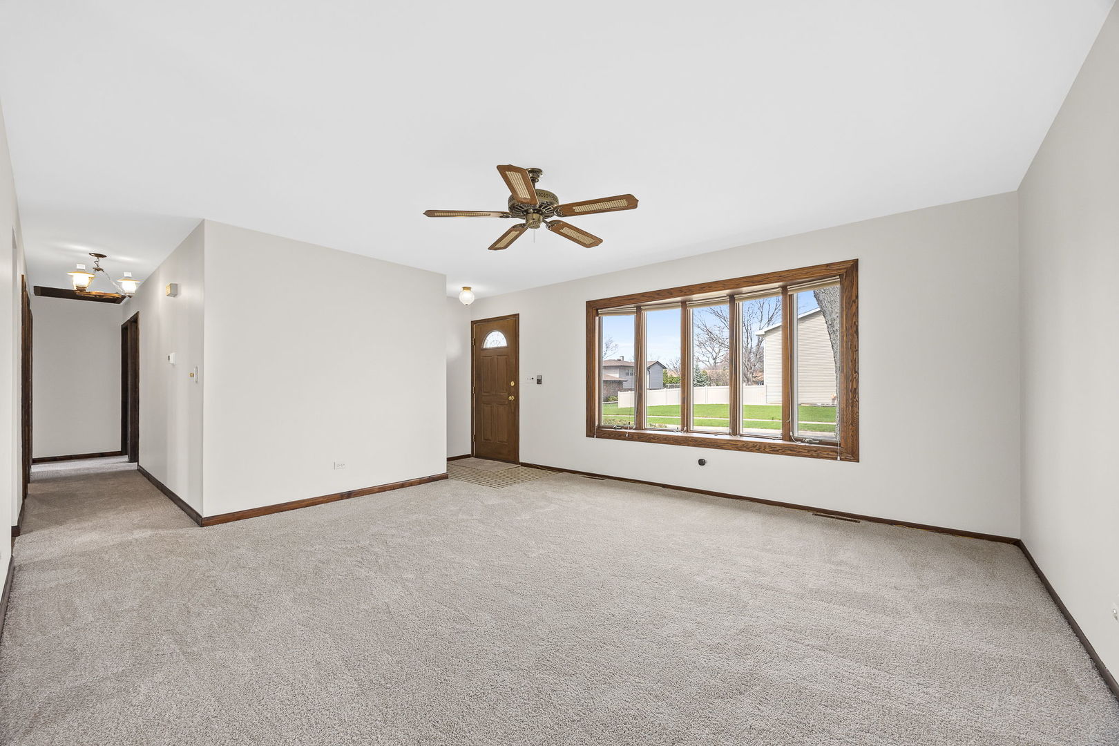 494 Flint Trail Carol Stream, IL 60188 - Photo 6 of 37 a view of a livingroom with a ceiling fan and window