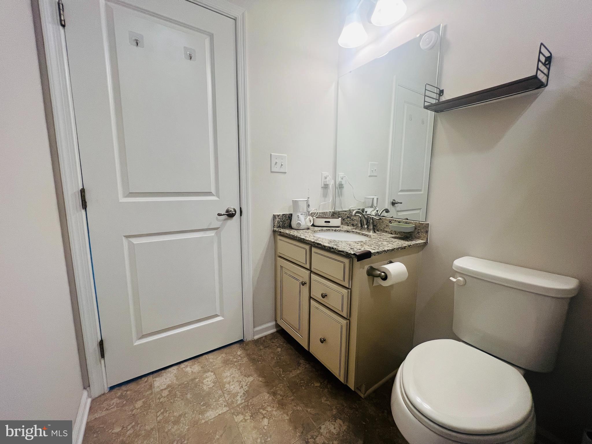 113 Patriots Path Malvern, PA 19355 - Photo 20 of 24 a bathroom with a sink a toilet a mirror and vanity