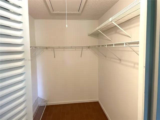 a white toilet sitting next to a shower