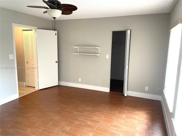 a view of a dining room with a table and chairs