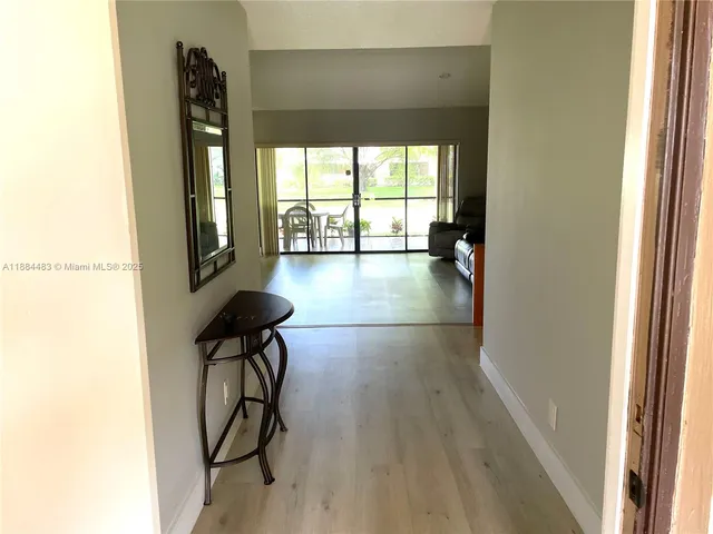 a view of entryway with wooden floor