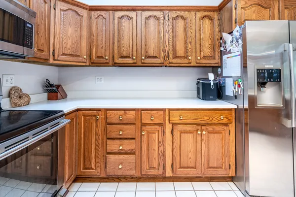 a kitchen with stainless steel appliances granite countertop a sink a stove cabinets and a counter top space