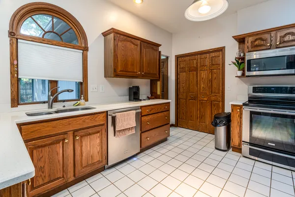 a kitchen with stainless steel appliances a stove a sink and a refrigerator