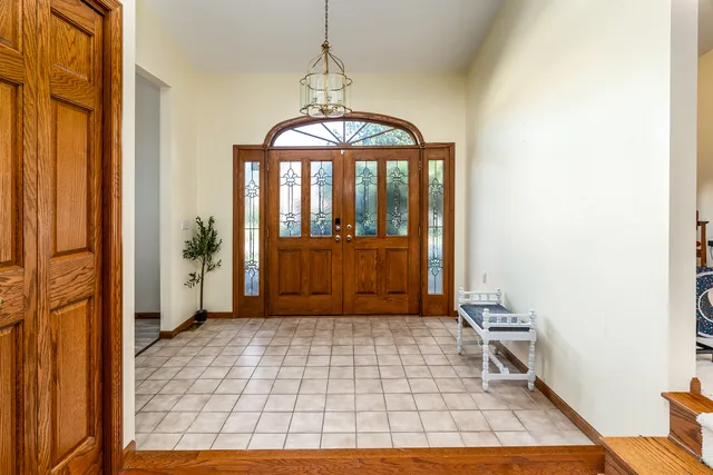 a view of a hallway with wooden floor and a dining room