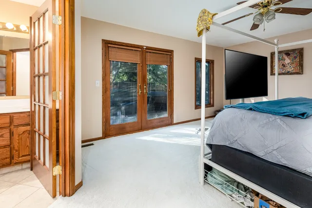 a bedroom with a bed and a large mirror with a flat tv screen