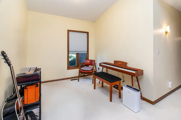 a living room with furniture and a piano