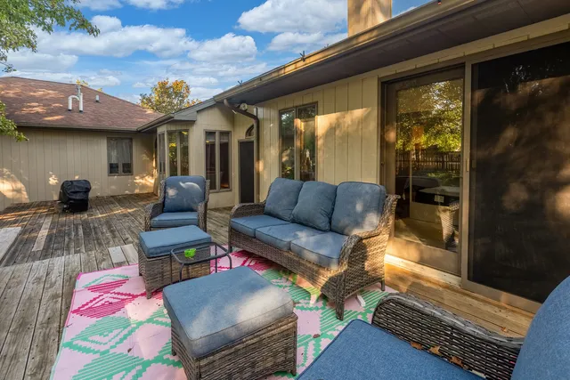 a roof deck with couch and chairs
