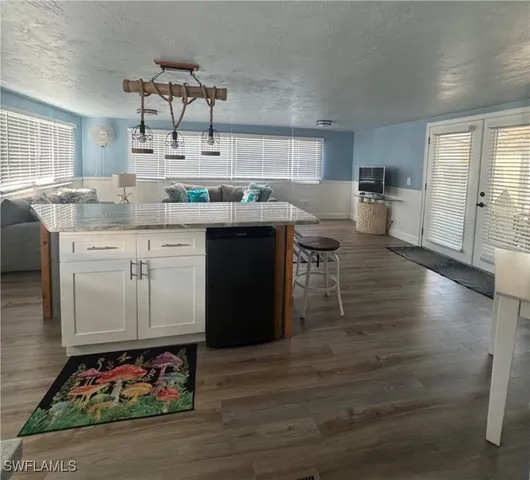 a kitchen with a sink cabinets and wooden floor