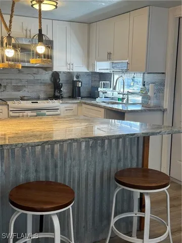 a kitchen with table chairs sink and stove