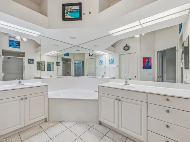 a spacious bathroom with a double vanity sink mirror and