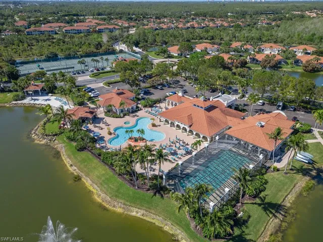 an aerial view of residential houses with outdoor space and swimming pool